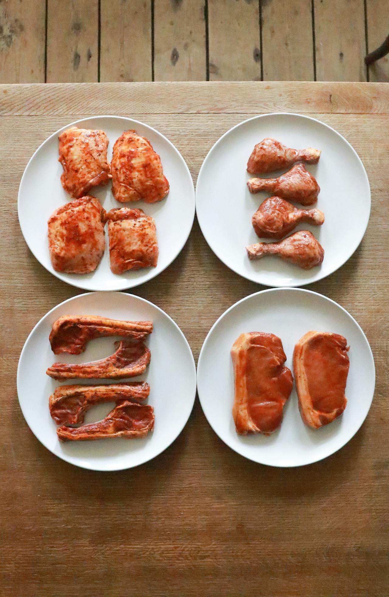 https://www.pexels.com/photo/plates-with-various-raw-meat-with-spices-on-table-6607314/